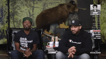 TV gif. Desus and Mero sit next to each other and look at us. Mero hands his hands up in praying position while Desus talks. 