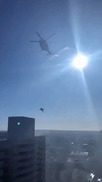 Helicopter Lowers Emergency Responder Onto Roof During LA High-Rise Blaze