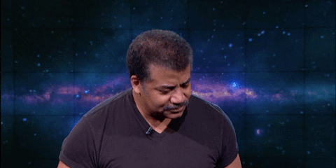 Celebrity gif. Neil Degrasse Tyson stands in front of an outer space background as he raises a hand over his head and looks ahead. Text, Can I get an Amen!