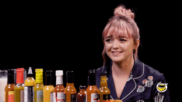 TV gif. As a guest on Hot Ones, a sheepish Maisie Williams hides behind a napkin and says, “Sorry.”