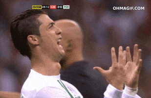 Sports gif. Cristiano Ronaldo is on the field and he looks massively distressed as he yells with both hands outwards shaking. He turns towards us and we see his face contorted in frustration and sadness